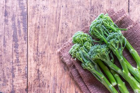 Fresh broccoli on wooden table close up and space for textの写真素材
