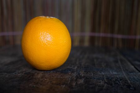 Close-up Orange on wood texture background with space for text.