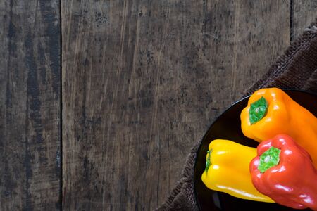 3 Sweet Peppers Beside on The Wood Table