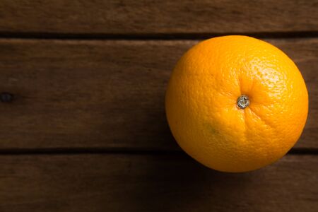 Fresh Orange on Wood Table Desk Background, Rustic Style.  and space for textの写真素材
