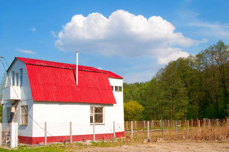 Summer cottage on the sunny day under a cloudの写真素材
