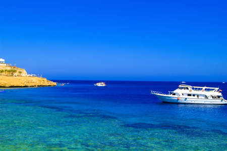 White yacht at the sea over the reef