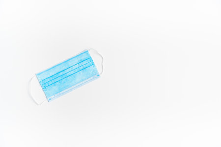 Surgical mask with rubber ear straps. Typical 3-ply surgical mask to cover the mouth and nose. Protection concept.の写真素材