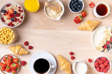Healthy breakfast set on wooden background. The concept of delicious and healthy food. Mix nuts, honey, berries, orange jus, pancake and milk. Top viの写真素材