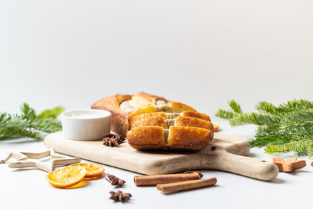Crispy banana bread with cinnamon on a gray concrete background. Christmas or New Years dessert. Christmas tree branches.の写真素材