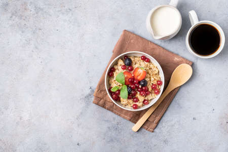 Breakfast table with granola, fresh berries and coffee with milk. Top view.の写真素材