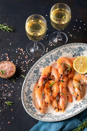 Fresh mussels in a sauce with white wine in transparent glasses. Seafood dinner on a black background.の写真素材