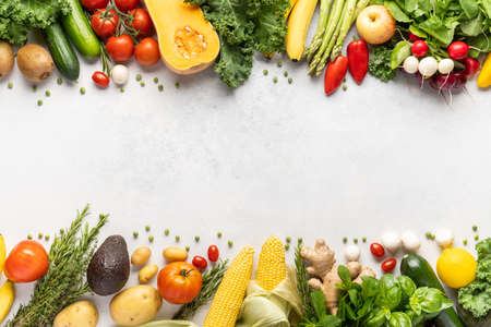 Gastronomic frame made of fresh vegetables and fruits . Top view, place inscriptionの写真素材