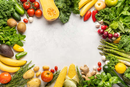 Gastronomic frame made of fresh vegetables and fruits . Top view, place inscriptionの写真素材