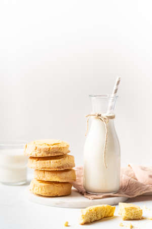 Freshly baked homemade honey cookies with milk for breakfast on a white backgroundの写真素材