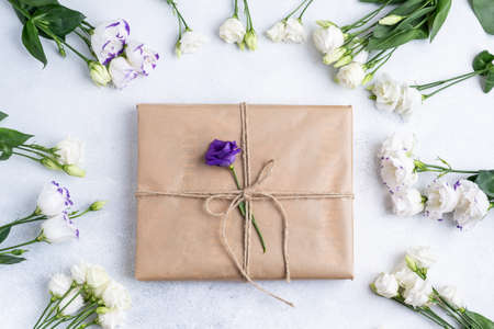The composition of flowers and bags. A gift and flowers on a pink background. Womens Day, a holiday. Flat sunbed, top view, copy space.の写真素材