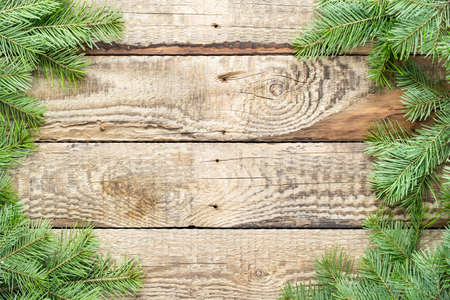 Christmas tree green branches on a wooden background. Decorations for Christmas and New Year. Top...