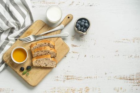 Breakfast board with toast, jam and orange juice.