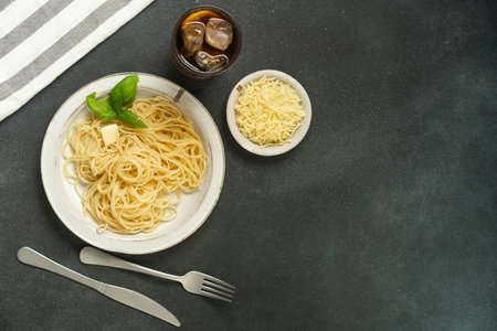 Flatlay of pasta with basil and parmesan on black background.の写真素材