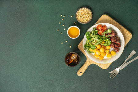 Fresh salad with sesame and vegetables on green cutting board.の写真素材