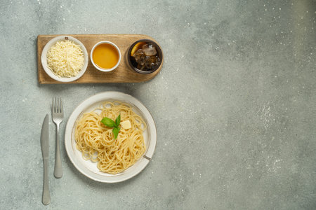 Pasta bowl with sauce, cheese and salad on gray surface.の写真素材