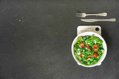 Bowl of salad with sesame and cherry tomatoes flatlay. High quality photoの写真素材
