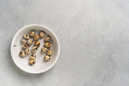 Bowl of quail eggs on gray concrete surface. High quality photoの写真素材