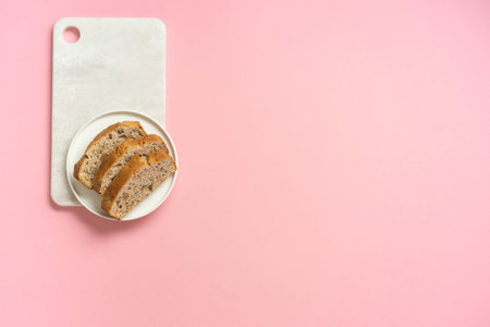 Sliced bread on white plate and pink background.の写真素材