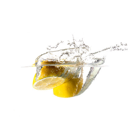Lemon splash on water, isolated on white background. Use for fresh drinks advertising.の写真素材