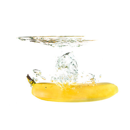 Banana splash on water, isolated on white background. Use for fresh drinks advertising.の写真素材