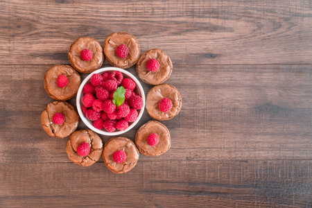 Chocolate lava cakes with fresh raspberries and mint, roundの写真素材