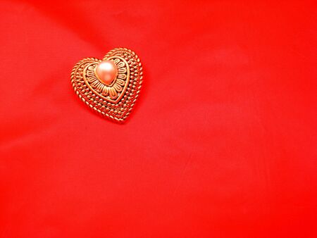 Gold And Pearl Heart on Redの写真素材