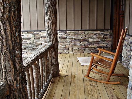 Deck With Rock Work, Log Railing, And Rocking Chairの写真素材
