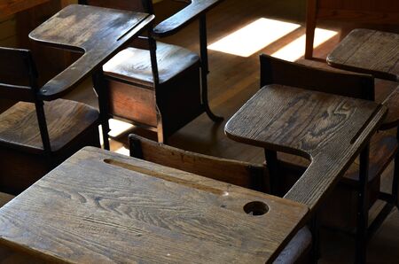An image of old wooden school deskes.の写真素材