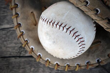 A top view image of an old baseball and baseball glove.の写真素材