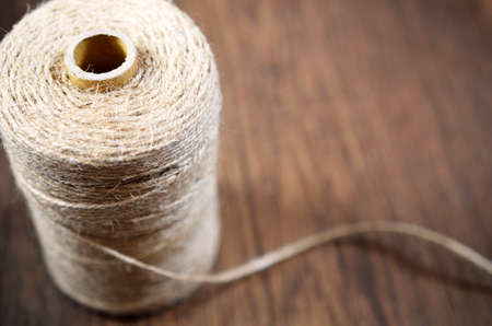 A side view image of a spool of craft thread.