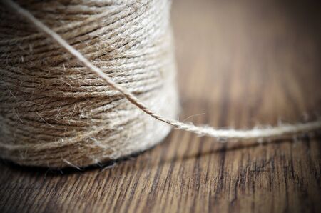 A side view image of a spool of craft thread.