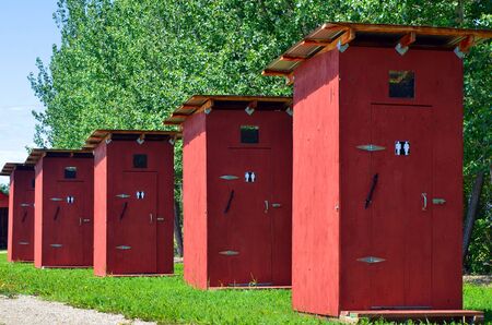 An image of five public out houses in a row.の写真素材