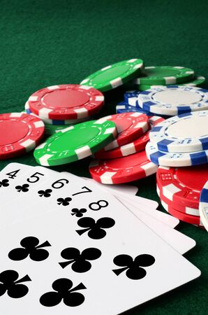 A top view image of poker chips and playing cards.