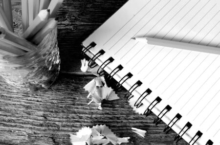 A top view image of an open notebook and several sharpened pencils.の写真素材