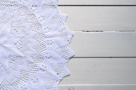 Crochet Lace Doily on a White Table Topの写真素材