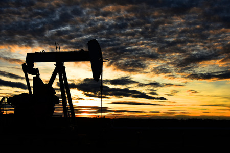 Working Pump Jack at Sunsetの写真素材