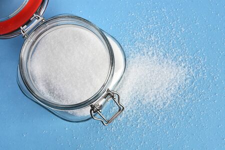Sugar Jar and White Sugar on a Blue Backgroundの写真素材