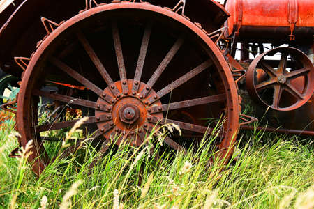 An mage of an old rusted metal tire on a vintage tractor.の写真素材