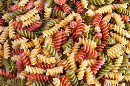 A top view image of multi-colored uncooked pasta.の写真素材