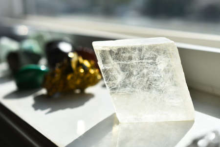 An image of clear Icelandic Spar calcite charging on a white window ledge.の写真素材