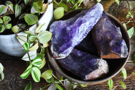A top view image of rough Canadian amethyst in a hand made pottery bowl.