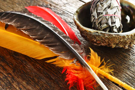 A close up image of colorful sacred feathers and white sage.の写真素材