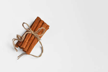 A top view image of a bundle of fresh cinnamon sticks on a white background.