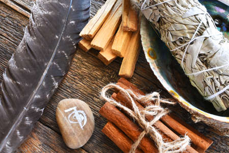 A top view image of white sage smudge stick with healing crystals, sacred feather and reiki symbol.の写真素材