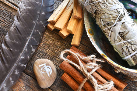 A top view image of white sage smudge stick with healing crystals, sacred feather and reiki symbol.の素材 [FY310159588839]