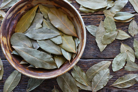 A top view image of dried bay leaved in a hand made pottery bowl.の写真素材