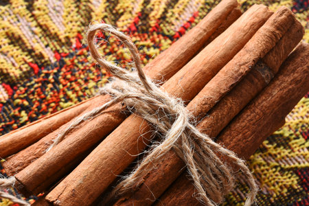 A close up image of several sticks of cinnamon in a bunch.
