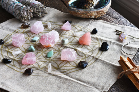 A close up image of a self love and self healing crystal grid using sacred geometry and rose quartz crystals.の写真素材