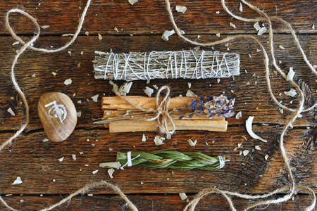 A top view image of healing smudge sticks with reiki symbol on a wooden table top.の写真素材